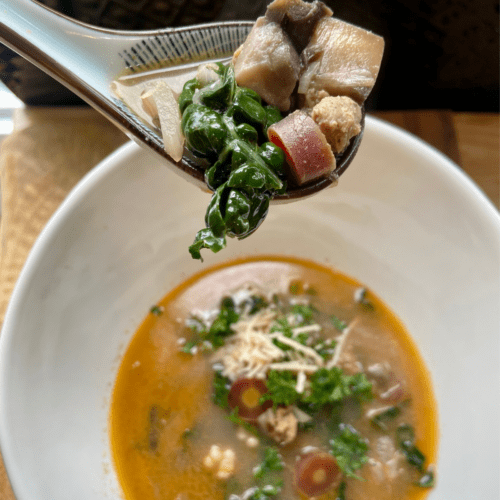 vegan sausage and couscous soup with kale, carrot, fennel