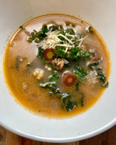 vegan sausage and couscous soup with kale, carrots, fennel, vegan palm