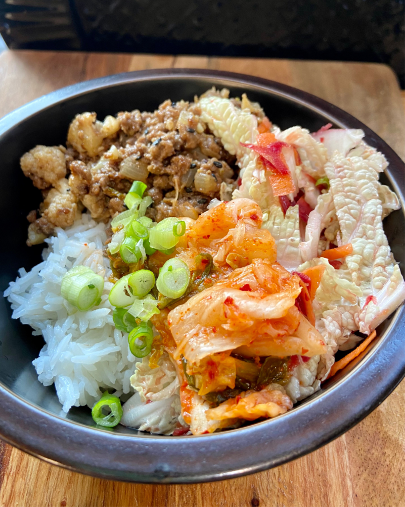 Vegan Bulgogi Bowl, made with plant-based “beef” tossed in sweet & spicy Bulgogi sauce, served with rice, kimchi, carrots, and cabbage. 