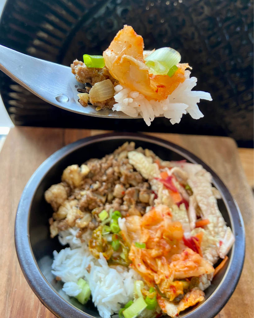 Vegan Bulgogi Bowl, made with plant-based “beef” tossed in sweet & spicy Bulgogi sauce, served with rice, kimchi, carrots, and cabbage. 