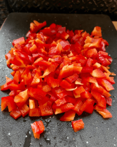 red pepper for Vegan taco stuffed with spicy five spice tofu crumble, Asian red pepper slaw, fresh sliced avocado, green onion.