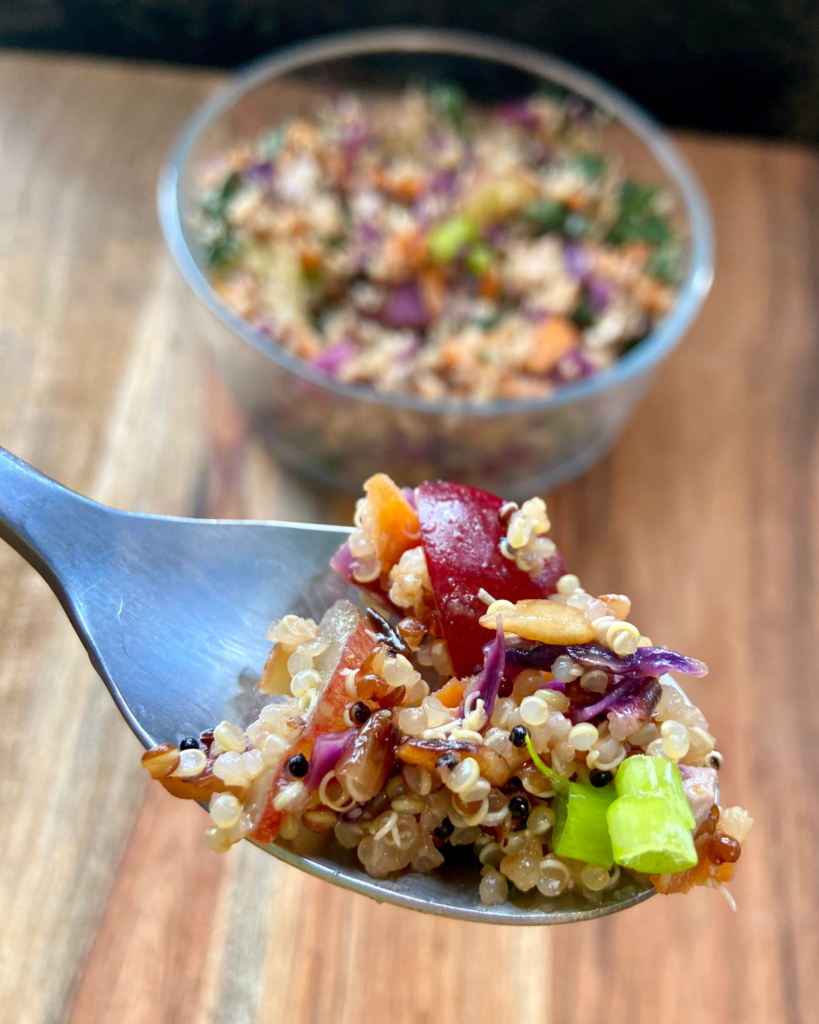 Tofu Almond Quinoa Salad made with grapes, kale, cabbage, carrots, cucumbers, and a savory Asian dressing. 