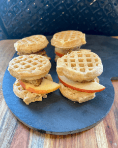 Vegan Waffle Sliders with Rosemary Maple. Vegan breakfast sausage and sliced apple, sandwiched between mini waffles and dipped in rosemary maple syrup.