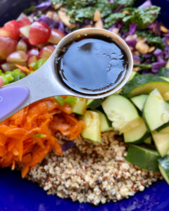 derision for Tofu and almond quinoa salad made with grapes, kale, cabbage, carrots, cucumbers, and a savory Asian dressing. 