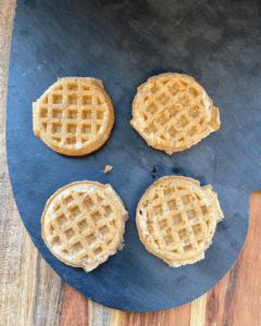 waffles for Vegan Waffle Sliders with Rosemary Maple. Vegan breakfast sausage and sliced apple, sandwiched between mini waffles and dipped in rosemary maple syrup.