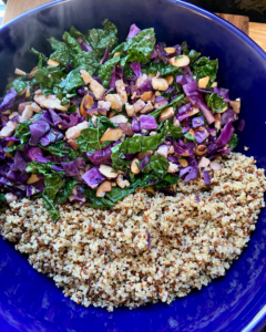 Tofu and almond quinoa salad made with grapes, kale, cabbage, carrots, cucumbers, and a savory Asian dressing. 