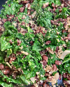 kale, quinoa and black beans for Vegan burrito, loaded with roasted sweet potatoes, toasted almonds, seasoned black beans, quinoa, kale, vegan cheese and topped with cilantro tomato salad, vegan sour cream, and avocado