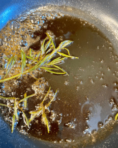 rosemary maple syrup for Vegan Waffle Sliders with Rosemary Maple. Vegan breakfast sausage and sliced apple, sandwiched between mini waffles and dipped in rosemary maple syrup.