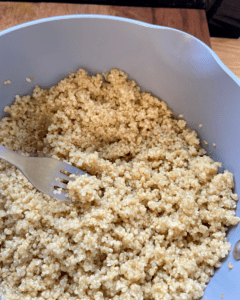 quinoa for Toasted macadamia nut and kale salad, served with seasoned quinoa, topped with sauerkraut and smoky tempeh. 