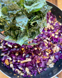 kale for Tofu and almond quinoa salad made with grapes, kale, cabbage, carrots, cucumbers, and a savory Asian dressing. 