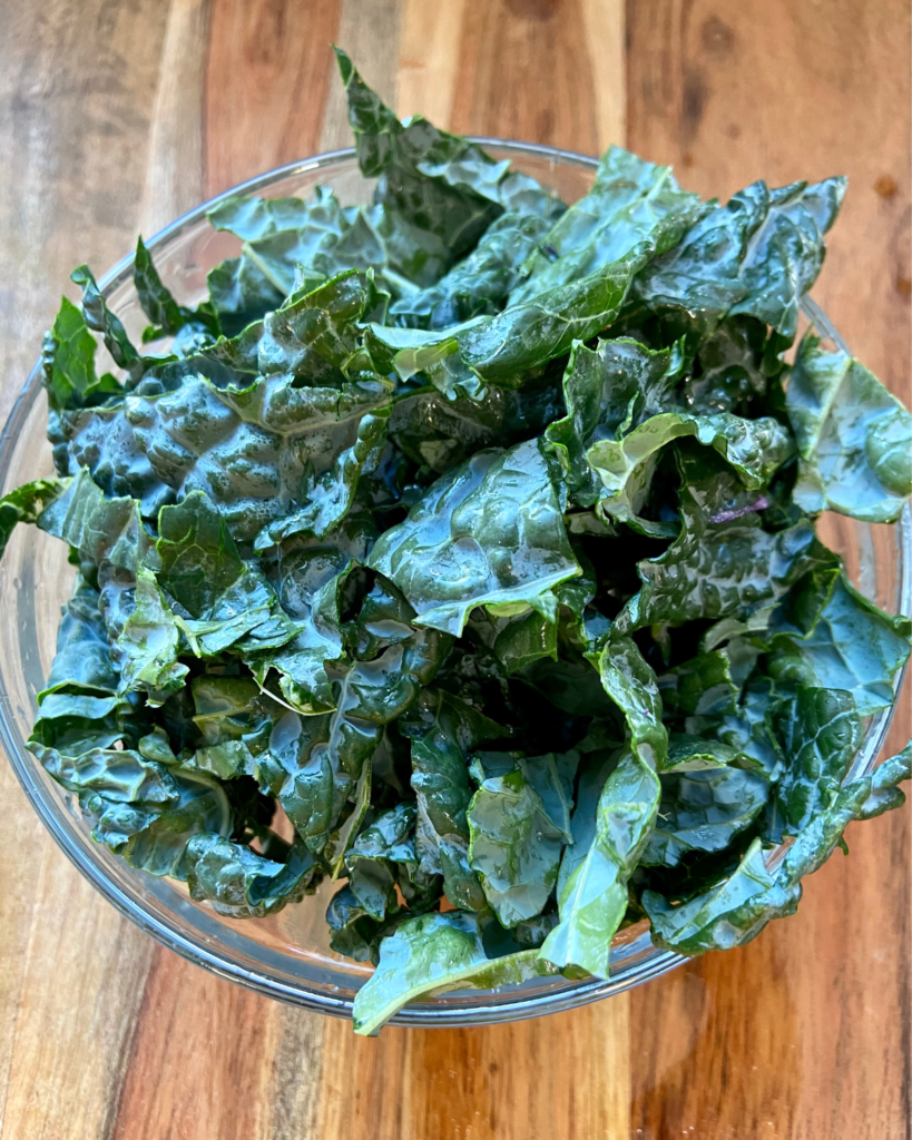 kale for Tofu Almond Quinoa Salad made with grapes, kale, cabbage, carrots, cucumbers, and a savory Asian dressing. 