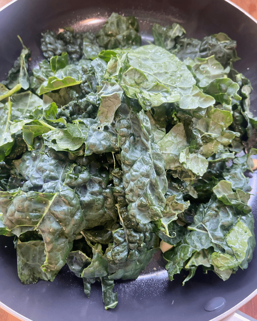 kale for Toasted macadamia nut and kale salad, served with seasoned quinoa, topped with sauerkraut and smoky tempeh. 