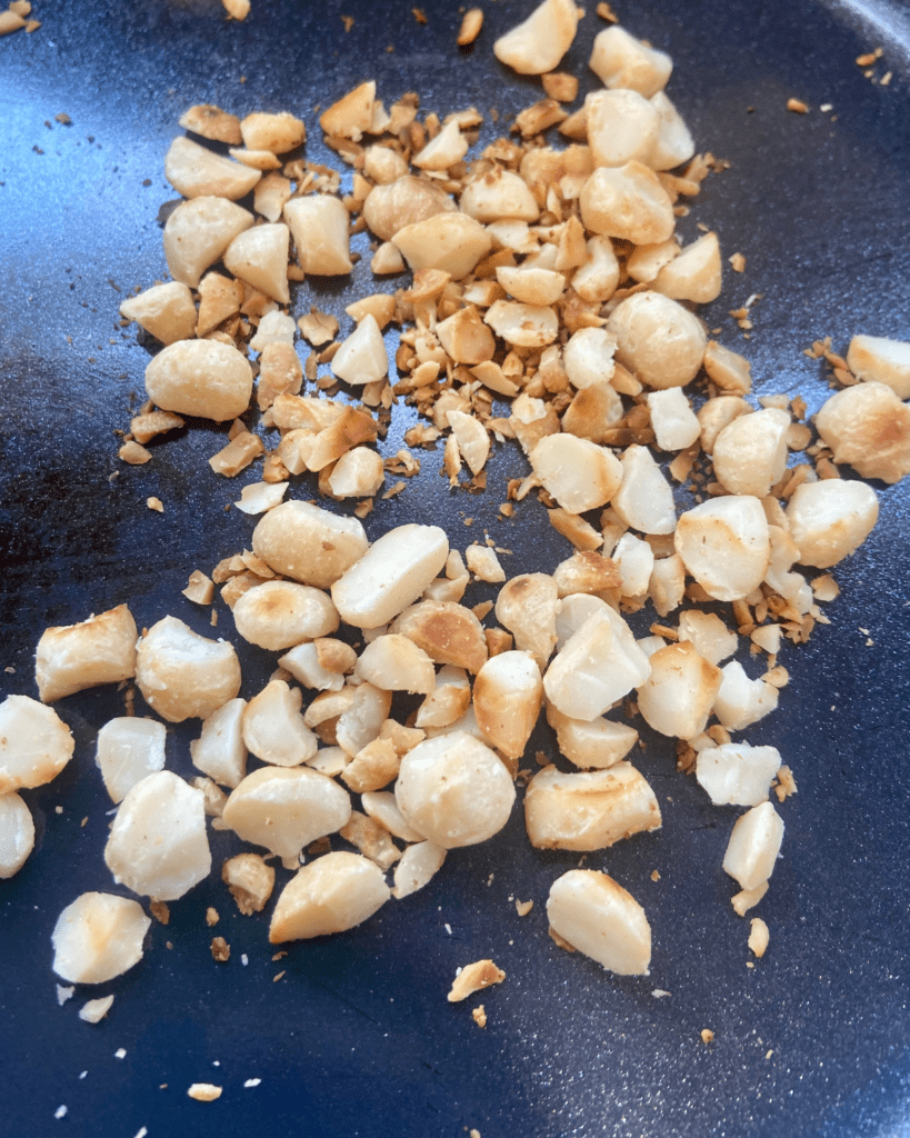 macadamia nuts for Toasted macadamia nut and kale salad, served with seasoned quinoa, topped with sauerkraut and smoky tempeh. 