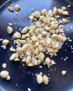 macadamia nuts for Toasted macadamia nut and kale salad, served with seasoned quinoa, topped with sauerkraut and smoky tempeh. 