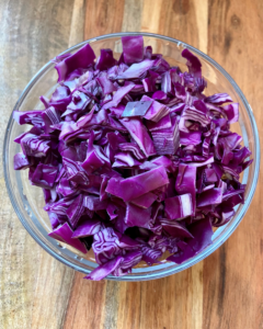 cabbage for Tofu and almond quinoa salad made with grapes, kale, cabbage, carrots, cucumbers, and a savory Asian dressing. 