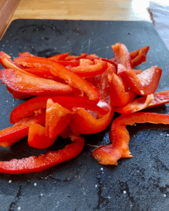 sliced red bell peppers for vegan fra diavolo recipe