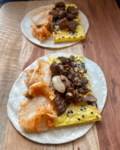 adding kimchi to vegan steak and egg taco