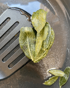 removing fried sage from the pan