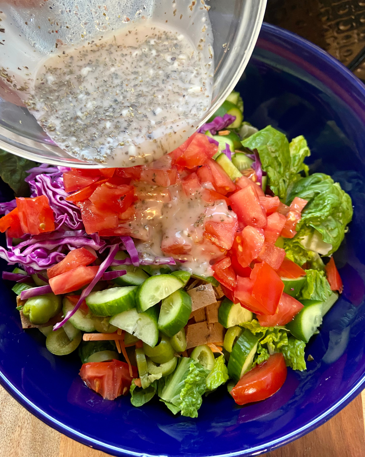 combining all ingredients for Italian hoagie sandwich salad vegan recipe