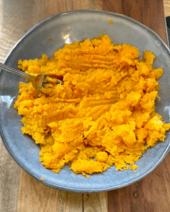 mixing butternut squash with ingredients