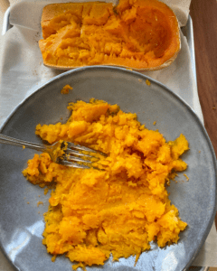 mashing butternut squash with fork