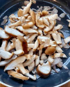 adding mushrooms to skillet