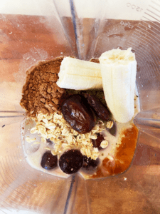 ingredients for chocolate cherry smoothie in a blender