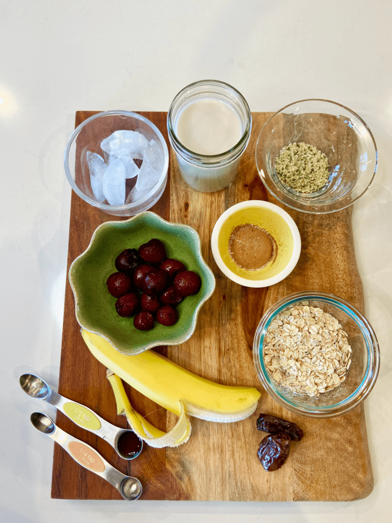 cherries, banana, oats, cocoa, hemp, ice, oat milk, dates for vegan smoothie recipe