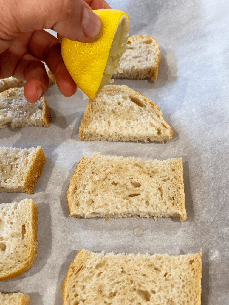 squeezing lemon on sourdough for vegan Italian starter