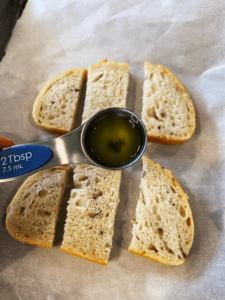 topping rosemary sourdough bread with olive oil