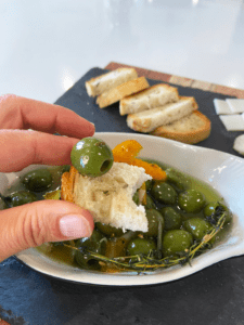 warm marinated olives and rosemary bread for charcuterie board