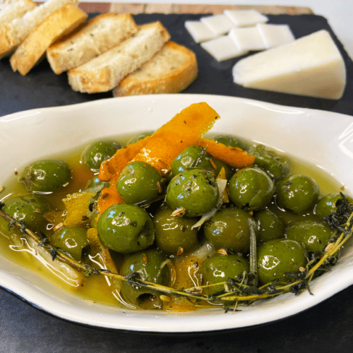 warm marinated olives and rosemary sourdough bread for charcuterie board