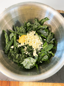 kale and dressing in a mixing bowl