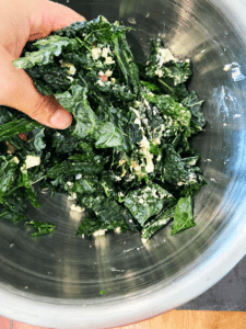 massaging kale with hands