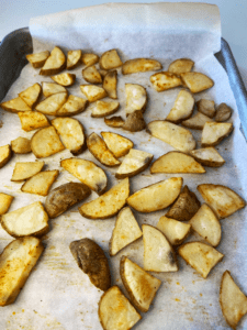 roasted potatoes on baking sheet for beyond steak tips recipe