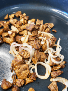 shallots and beyond vegan steak tips in pan