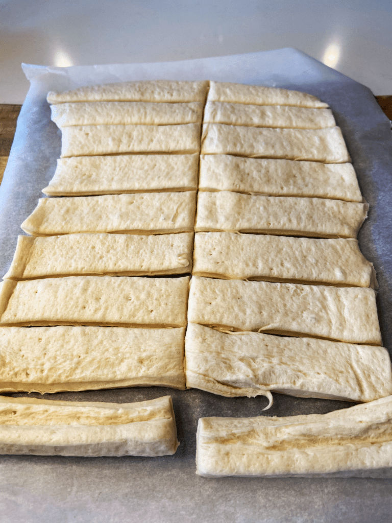 pillsbury dough on parchment paper  for Easy Garlic Knots Using Pillsbury Dough