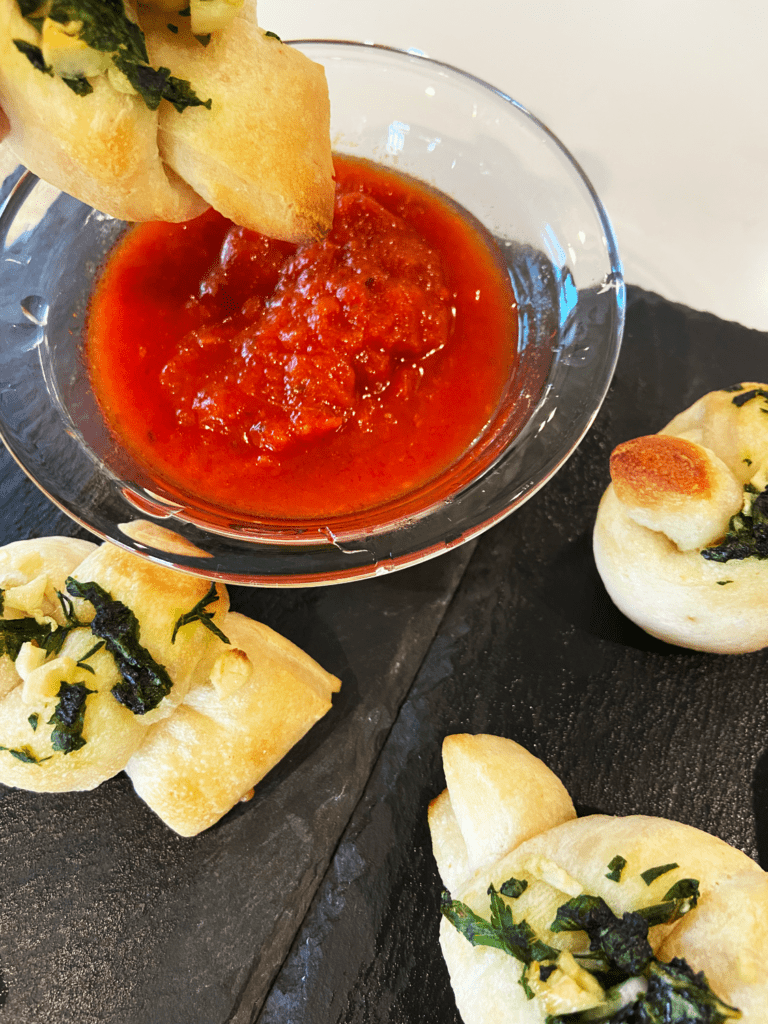 Pillsbury garlic knots dipped in pizza sauce