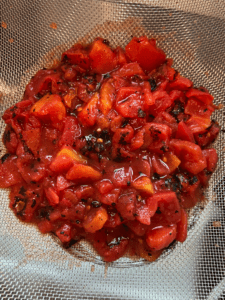 canned fire roasted tomatoes in strainer