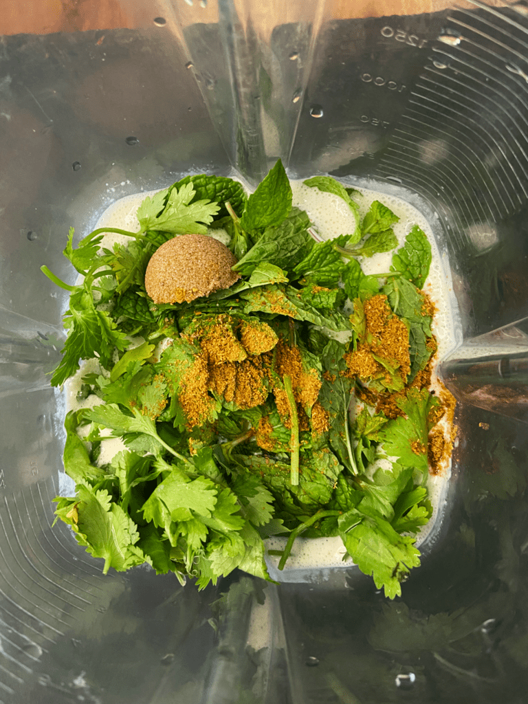 ingredients for cilantro mint vegan crema in a blender
