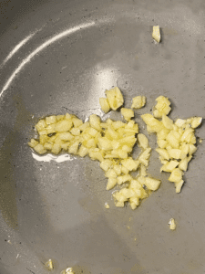 sautéed garlic in a pan for Guinness vegan cheese sauce