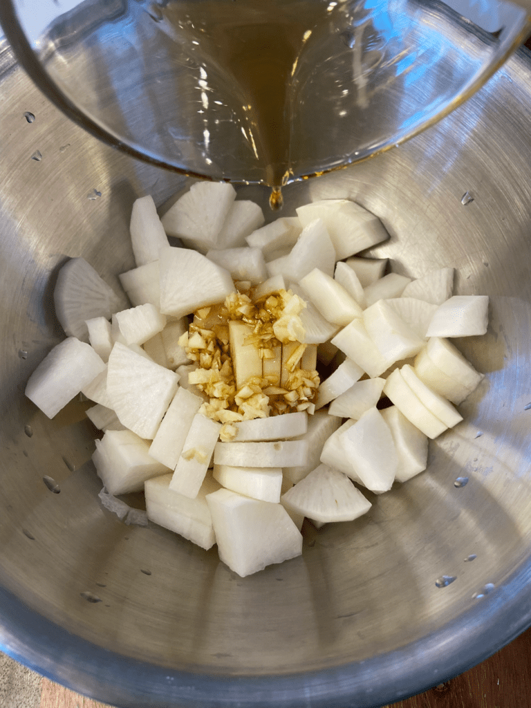 seasoning daikon radishes in a bowl