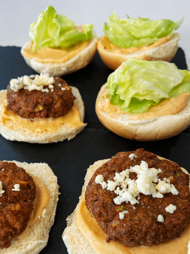 air fryer beyond meat burgers vegan buffalo blue sliders being topped