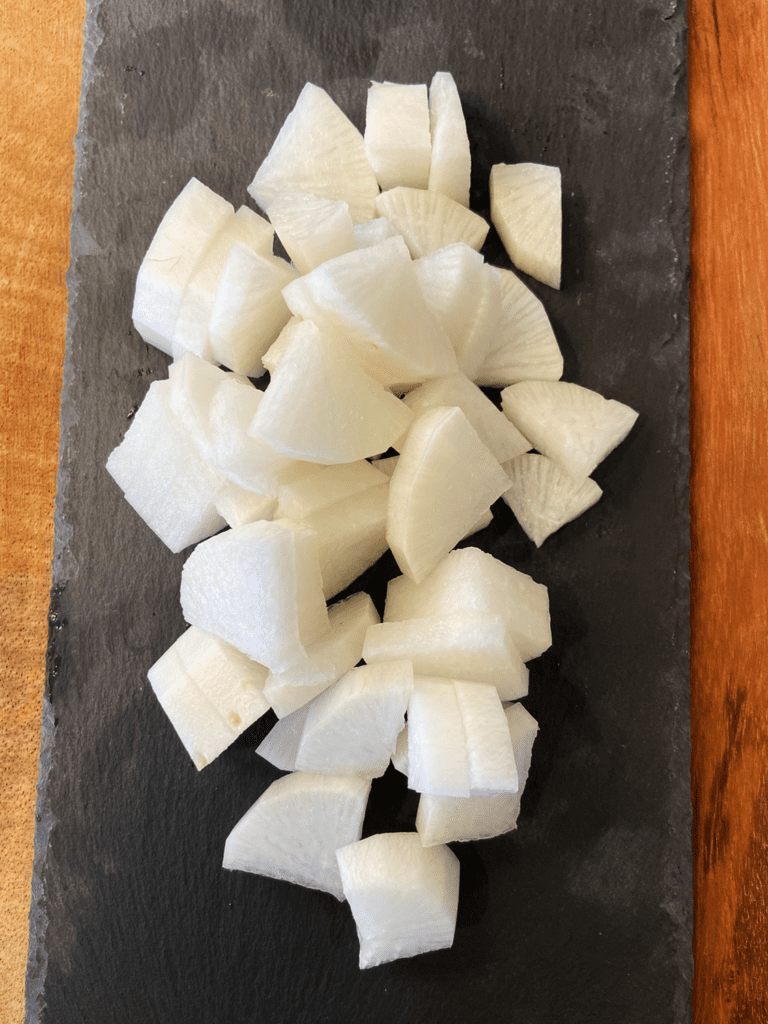 daikon radishes cut on a board