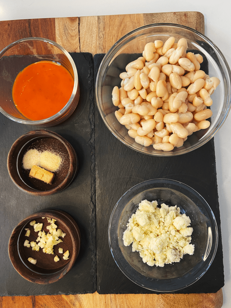 ingredients for white bean buffalo dip with vegan blue cheese crumbles