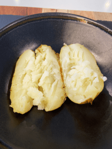 baked potatoes mashed with a fork for vegan bangers and mash baked potatoes