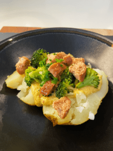 vegan Irish loaded baked potatoes with bangers, broccoli and Guinness cheese sauce