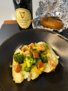 vegan Irish loaded baked potatoes with bangers, broccoli and Guinness cheese sauce