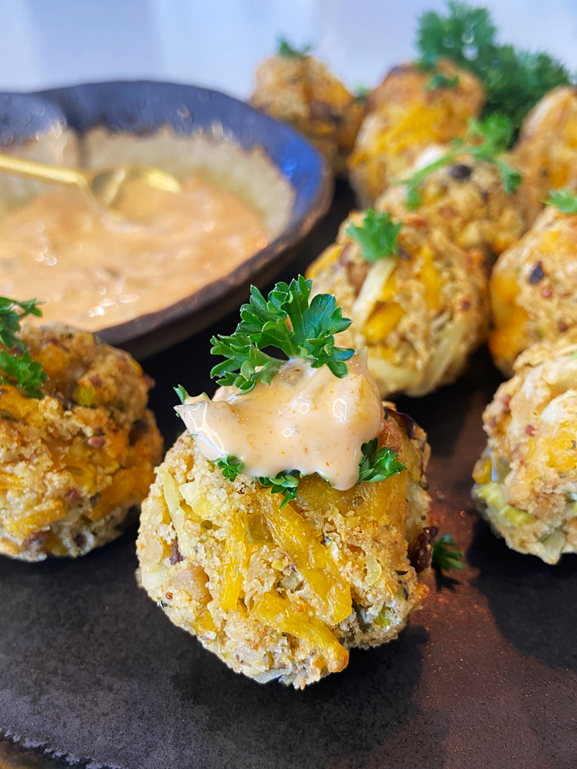 air fryer cheesy vegan crab bites and Old Bay Sriracha Aioli