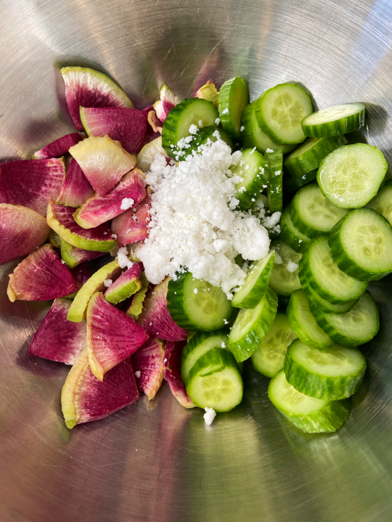 ingredients for air fryer watermelon radish cucumber salad in a bowl